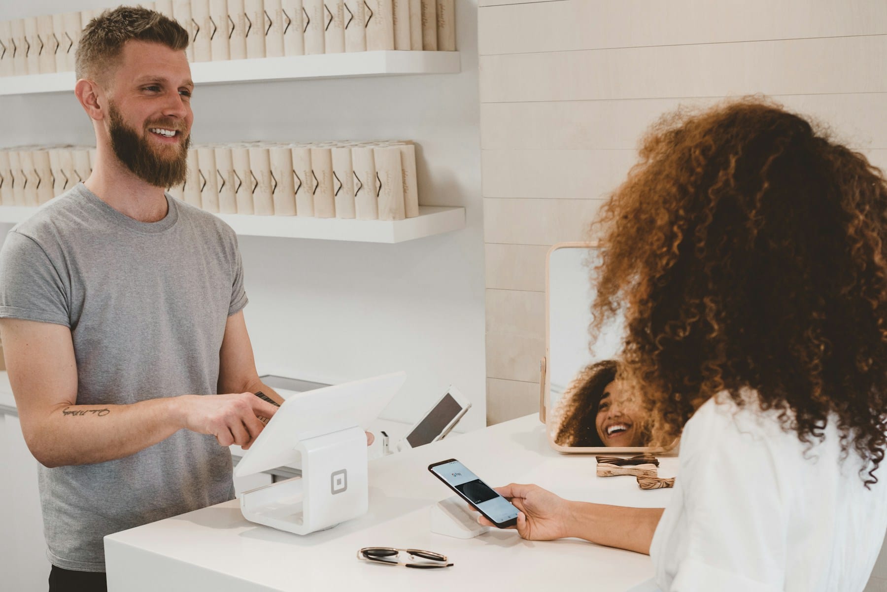 A shop owner serving a customer at the counter