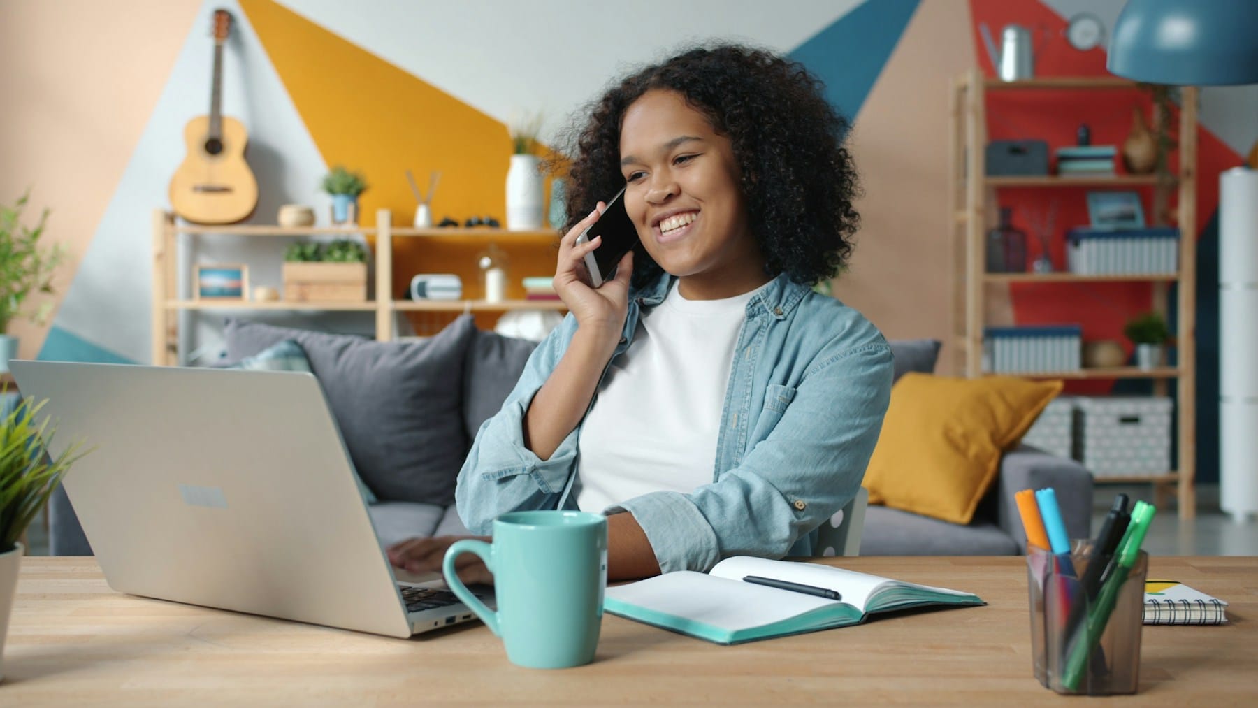 A freelancer on a call while working at her laptop