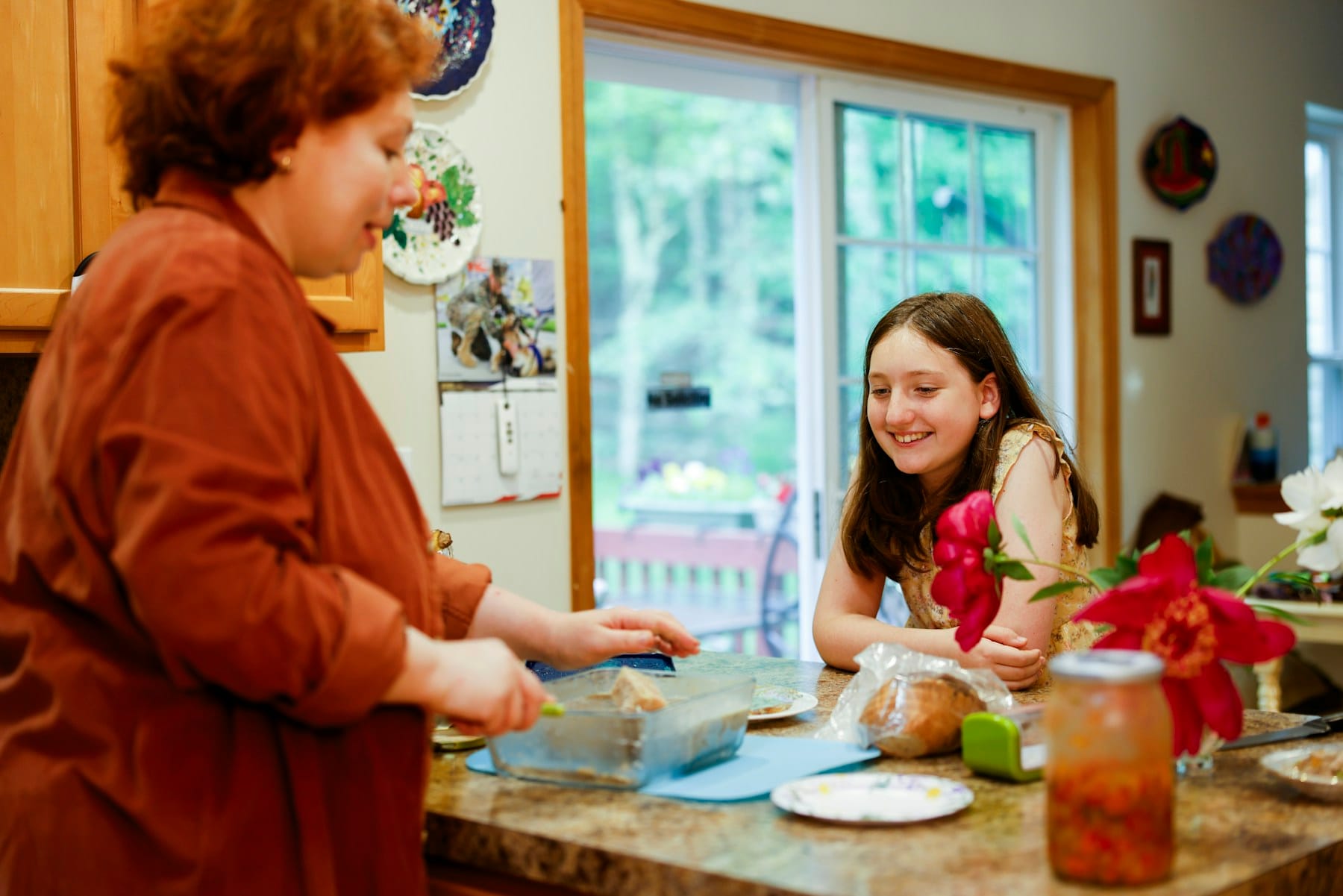 A mother and daughter preparing food in the kitchen